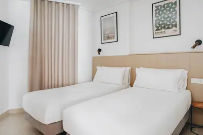 two beds in a hotel room at White Beach Apartment in Valencia