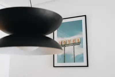 a black chandelier hanging in front of a picture at White Beach Apartment in Valencia
