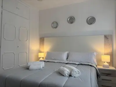 a bedroom with a large bed with two towels on it at Relax & Sea View & Beach Access in Faro de Cullera