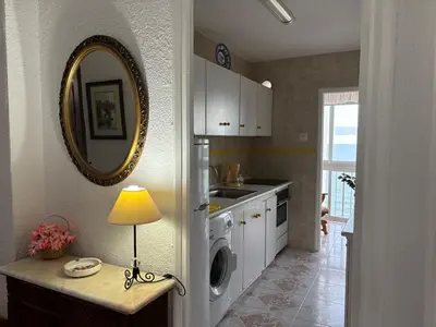 a kitchen with a sink and a table with a lamp at Relax & Sea View & Beach Access in Faro de Cullera