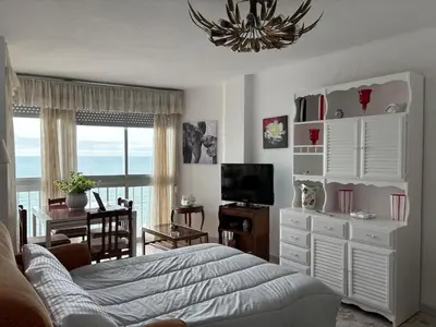 a bedroom with a bed and a desk and a television at Relax & Sea View & Beach Access in Faro de Cullera