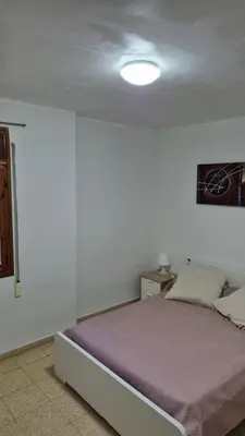 a bedroom with a bed in a white room at CANET de BERENGUER in Canet de Berenguer