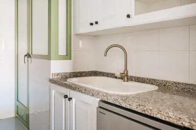 a white kitchen with a sink and white cabinets at Seaview Flat Patacona in Valencia