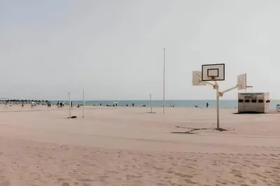 a basketball hoop on a beach with people in the background at Seaview Flat Patacona in Valencia