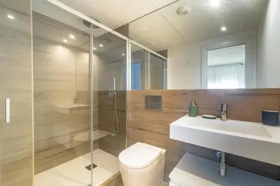 a bathroom with a toilet and a sink and a shower at Central Market Deluxe Apartments in Valencia