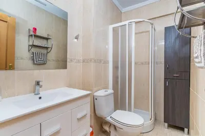 a bathroom with a toilet and a sink and a shower at Apto Playa Puebla de Farnals cerca de Valencia in Puebla de Farnals