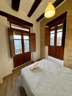 a bedroom with a bed and two windows at Piso 3 - Apartamento Mercado Central in Valencia