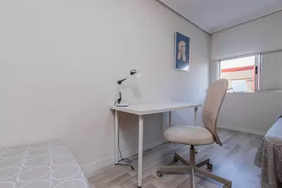 a room with a desk and a chair and a bed at Apartamento en el Cabanyal enfrente de la Marina Real in Valencia
