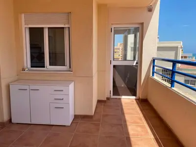 a balcony with a white cabinet on a building at Casa Ivan in Tavernes de Valldigna