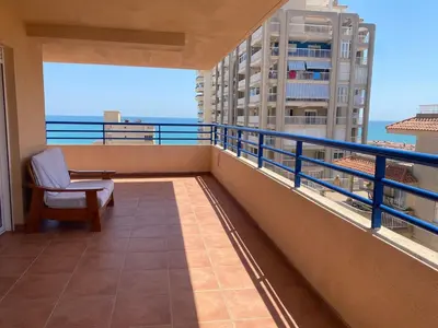 a balcony with a chair and a view of the ocean at Casa Ivan in Tavernes de Valldigna