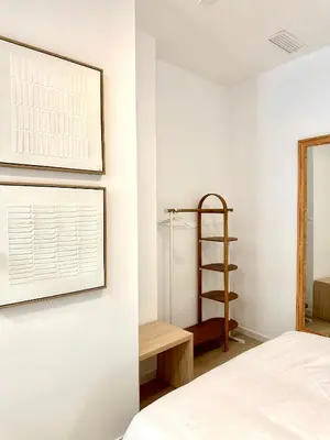 a bedroom with a bed and a shelf and a window at Anelsa Suites Serranos 1 in Valencia