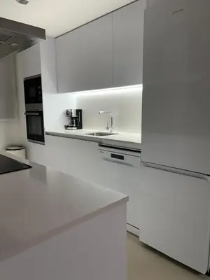 a white kitchen with a sink and a refrigerator at Apartamento Luxury in Valencia