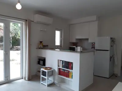 a white kitchen with a counter and a refrigerator at Casa Kiosko 2 bedroom chalet with swimming pool in La Eliana