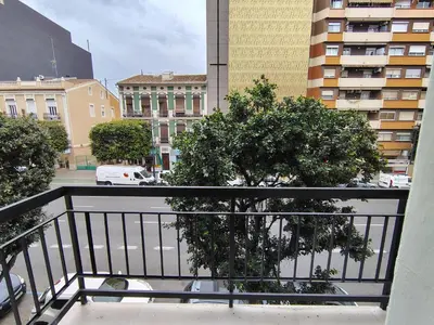 a balcony with a tree on a city street at Mandarina Suites - Unique apartments in Valencia in Valencia