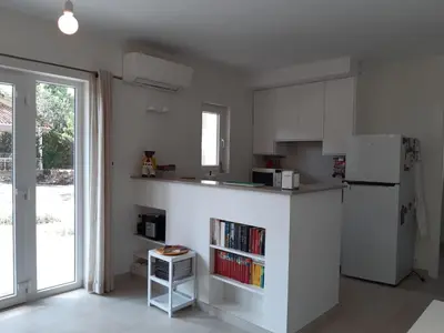 a white kitchen with a refrigerator and a book shelf at Casa Kiosko 3 bedroom chalet with swimming pool in La Eliana
