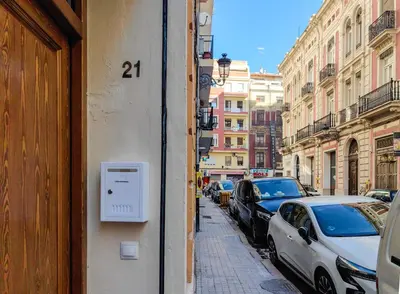 a street with cars parked on the side of a building at Casa Montserrat in Valencia