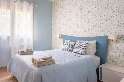a bedroom with a blue bed with towels on it at Luxury villa close to beach, mountain and golf! in Alzira