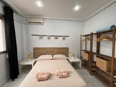 a bedroom with a bed with two pillows on it at Casa Lúmina Laura-Valencia in Valencia