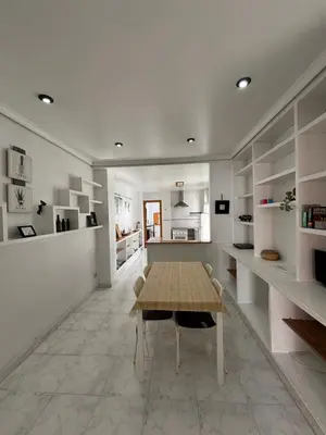 a dining room with a table and a kitchen at Casa Lúmina Laura-Valencia in Valencia