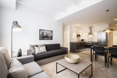 a living room with a couch and a table at Apartamentos La Marina in Valencia