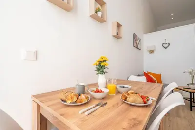 a wooden table with two plates of food on it at Vlc Yako Suite in Valencia