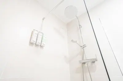 a shower in a bathroom with white walls at Vlc Yako Suite in Valencia