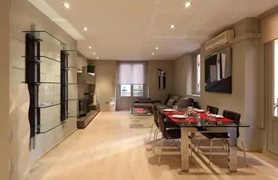a dining room and living room with a table and chairs at Apartamento Plaza Reina in Valencia