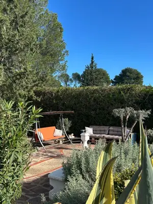 a garden with a bench and a table and chairs at Finca Malata in Turís