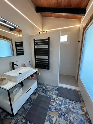 a bathroom with a white sink and a shower at Finca Malata in Turís