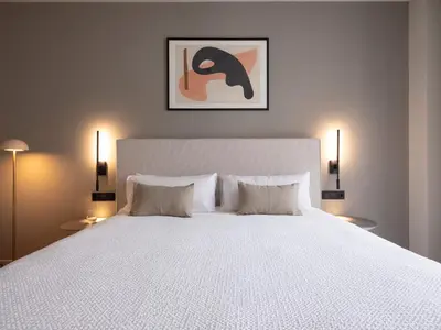a bedroom with a bed with a table next to it at Numa Valencia El Carmen in Valencia