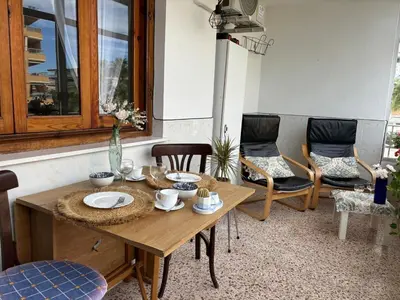 a dining room with a wooden table and chairs at Parking Privado l Terraza Relajante Junto Al Mar in Tavernes de Valldigna