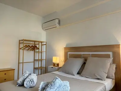 a bedroom with a large bed with white pillows at Parking Privado l Terraza Relajante Junto Al Mar in Tavernes de Valldigna
