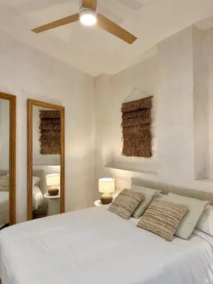 a bedroom with a white bed with two pillows at Anelsa Suites Serranos 3 in Valencia
