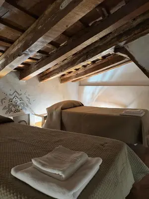 a bed with two towels sitting on top of it at Piso 4 - Apartamento Mercado Central in Valencia