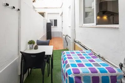 a small balcony with a table and chairs in a room at Cómodo apartamento cerca del metro y de la feria Valencia in Paterna