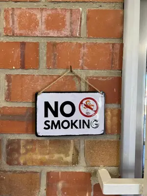 a no smoking sign on a brick wall at Cómodo apartamento cerca del metro y de la feria Valencia in Paterna