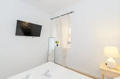 a white room with a flat screen tv on the wall at GuestReady - Cozy flat in Valencia in Valencia