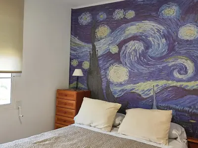 a bedroom with a painting on the wall at La Casa de los Alemanes in Gaibiel