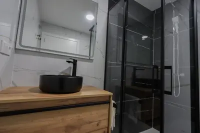 a bathroom with a black sink and a shower at La plata 59 in Valencia