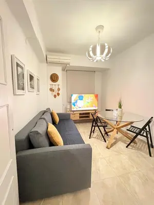 a living room with a couch and a table at UIM Mediterraneo Virgen del Carmen 2 Wifi in Puerto de Sagunto