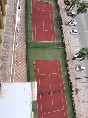 an overhead view of tennis courts on a street at Arensol Playa de Cullera in Cullera