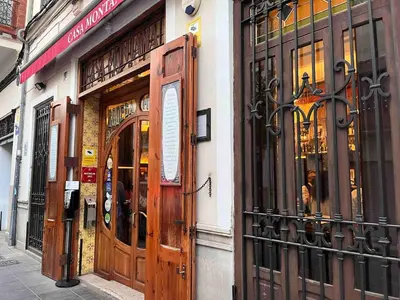 a store front with wooden doors on a street at Family Sea & Home Cabanyal in Valencia