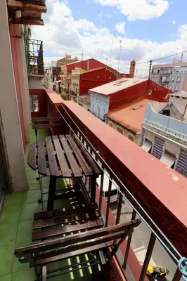 a wooden bench sitting on top of a balcony at 2 Bed Apartment, Great Location, 500M from Beach in Valencia