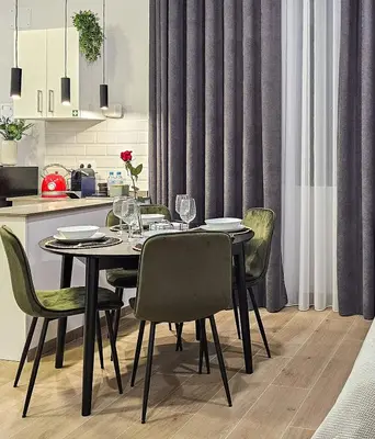 a dining room table with chairs and a kitchen at New Apartment Ruzafa - Art Nouveau in Valencia