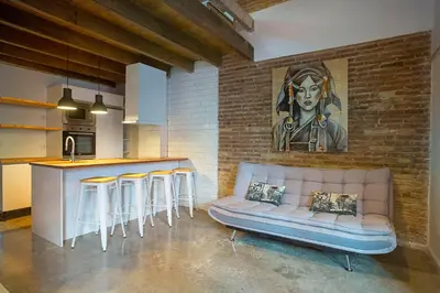 a living room with a couch and a bar at Cozy loft style apartment in El Cabanyal in Valencia