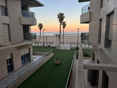 a view of the beach from the balcony of a building at Apartamento Mare Nostrum in Valencia