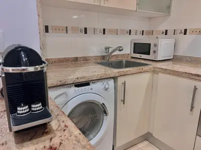 a kitchen with a washing machine and a sink at Apartamento Mare Nostrum in Valencia