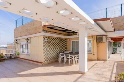 a white pergola on a patio with a table at Dictrict Key - Pobla de Farnals, Carabelas in Puebla de Farnals