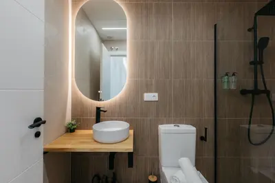 a bathroom with a toilet and a sink and a mirror at Design loft in Valencia in Valencia