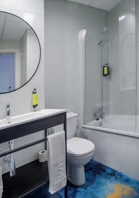 a bathroom with a toilet and a sink and a mirror at Hotel Sercotel Plana Onda in Onda